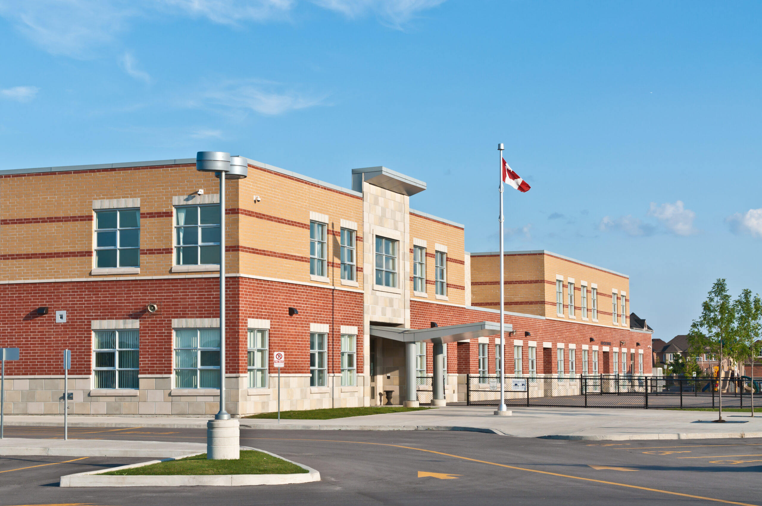 Modern elementary school building with brick façade and large windows, representing K–12 education construction and facility development